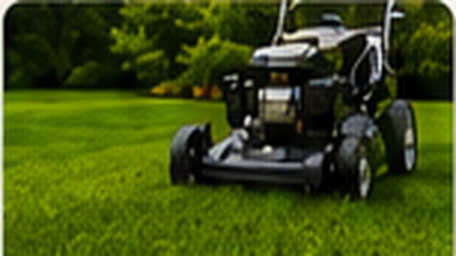 Lawn mower cutting a healthy green lawn